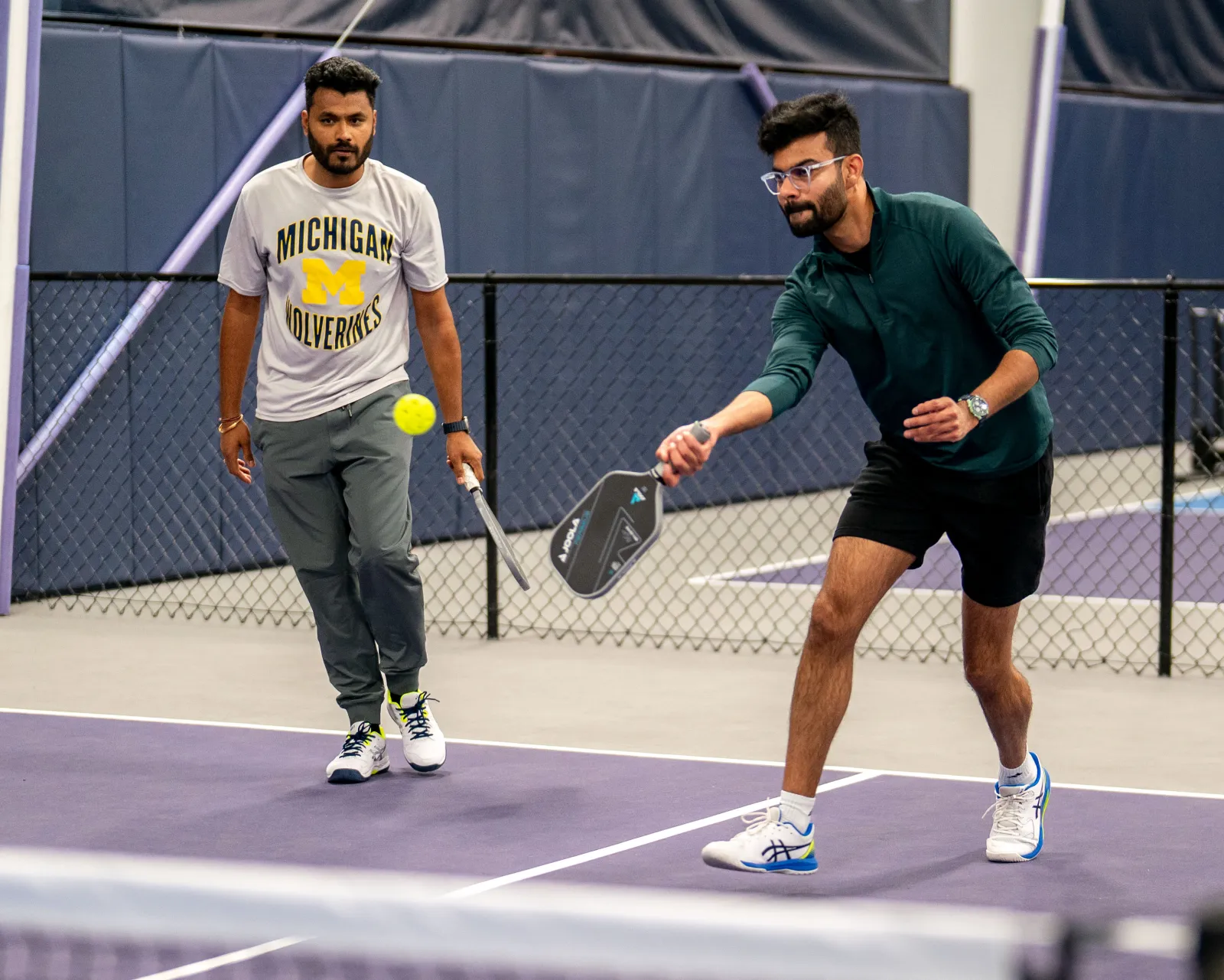 Two players rallying during Desi Nights at Pickleland