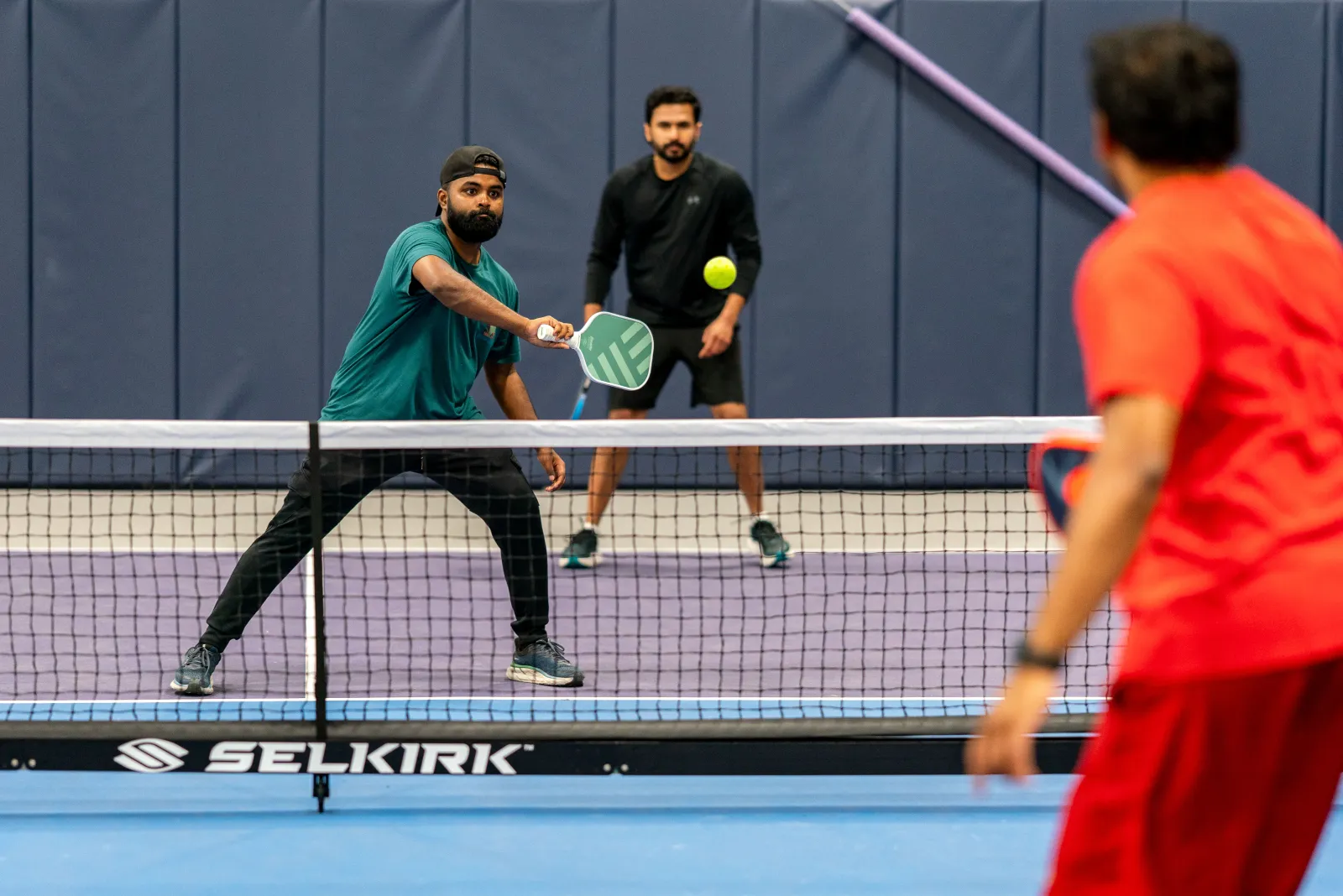 Players at the net during a Desi Nights game
