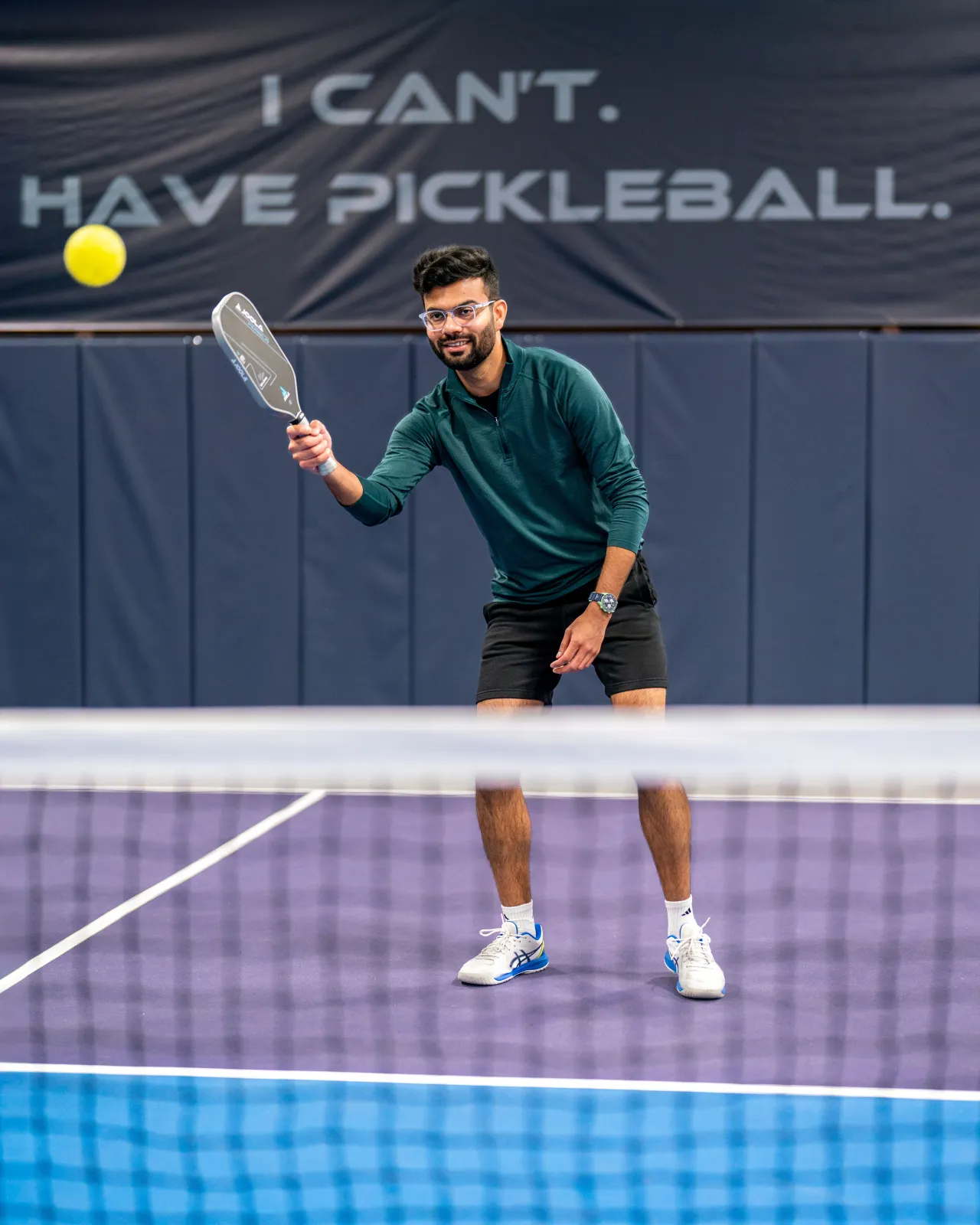 A player hits a forehand during Desi Nights at Pickleland