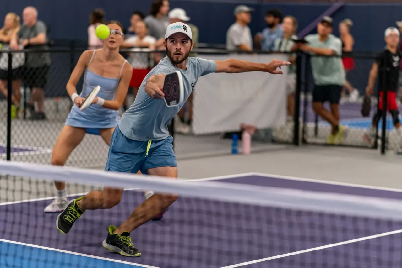Singles player stretching for a volley during a tournament