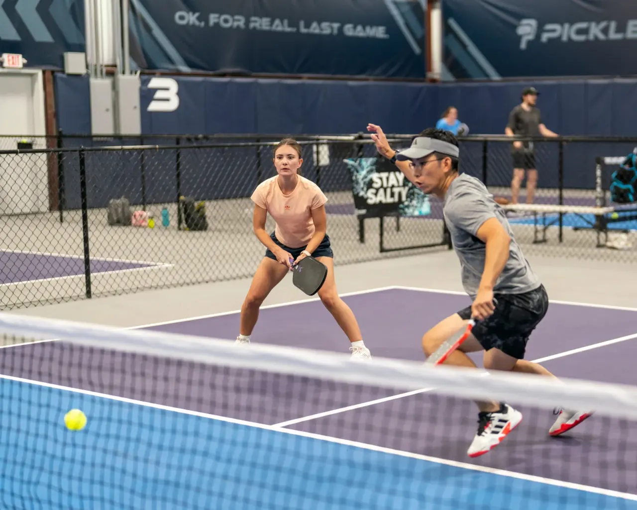 Mixed team of players at the net during an MLP-style tournament