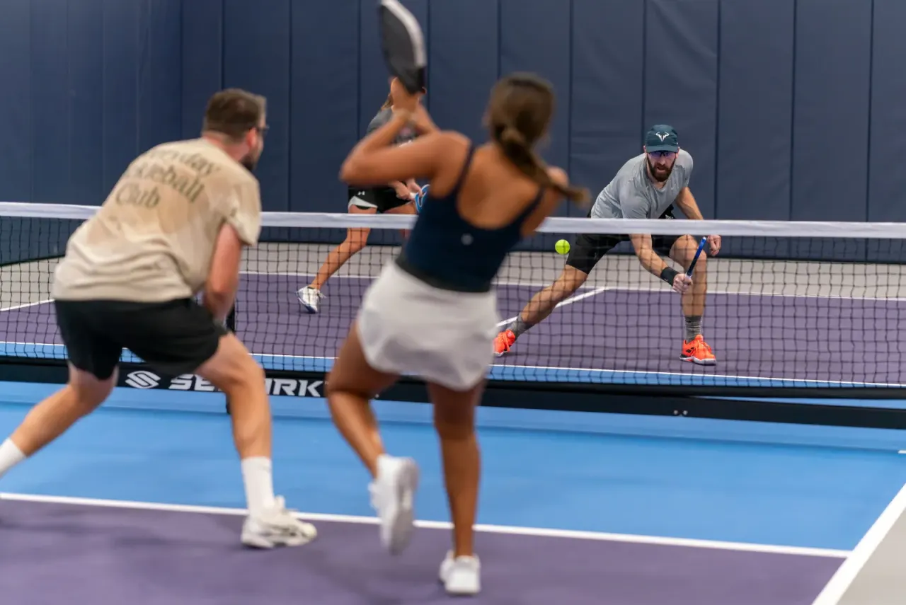 Mixed doubles pickleball action at Pickleland