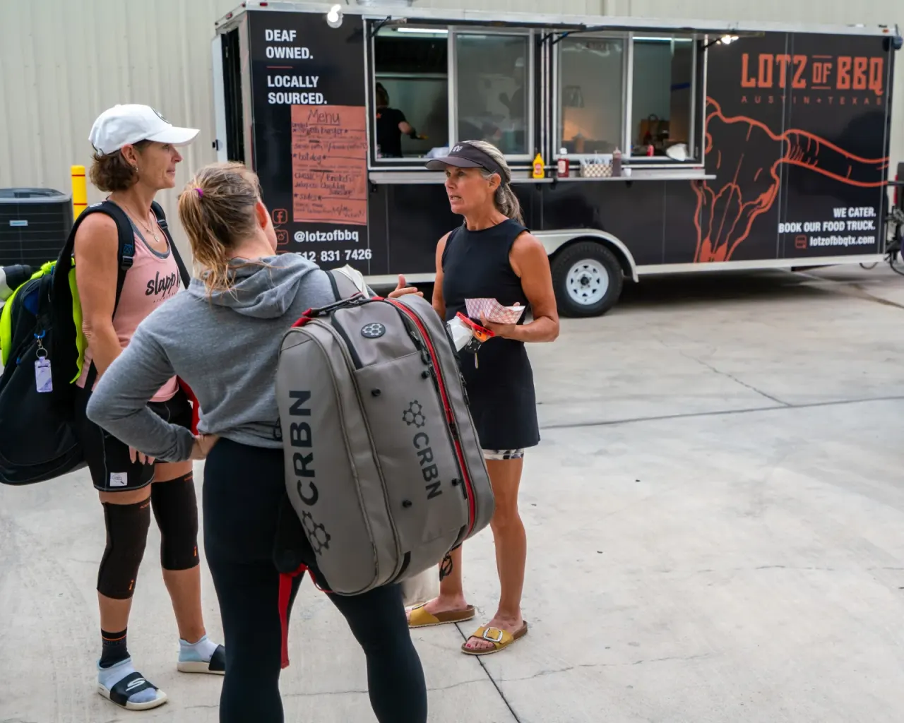 Guests enjoying a food truck at a Pickleland social
