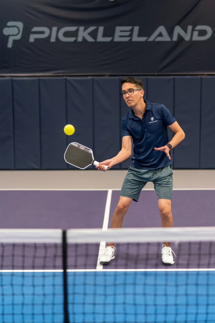 Alejandro Rioja, founder of Pickleland, hitting a forehand on court