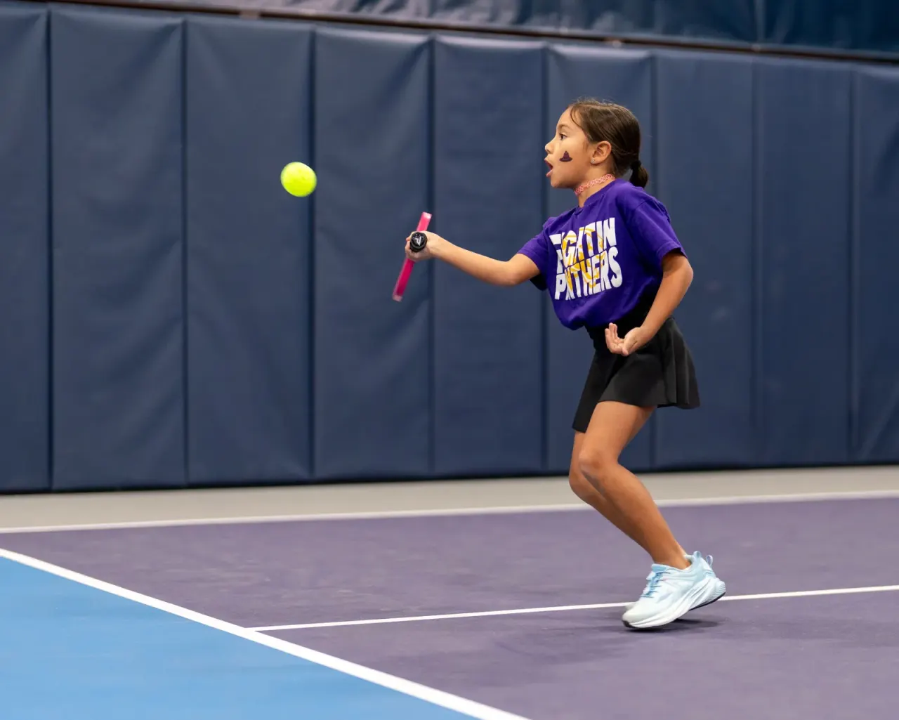 Young girl in purple rallies during a youth clinic