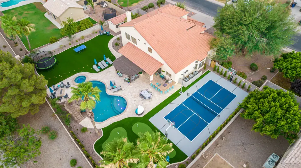 The Grand Saguaro Gilbert Arizona home with a regulation outdoor pickleball court and pool