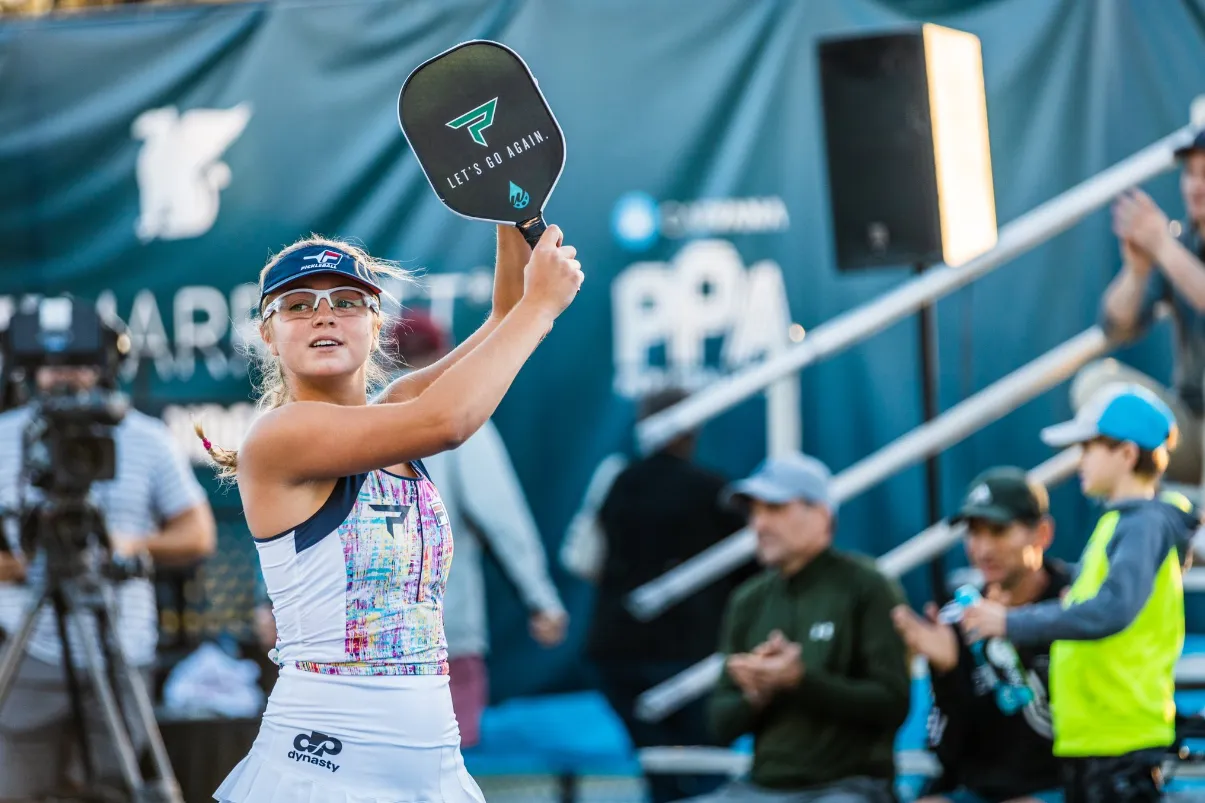 Anna Leigh Waters raising her paddle to celebrate a win at a PPA Tour event