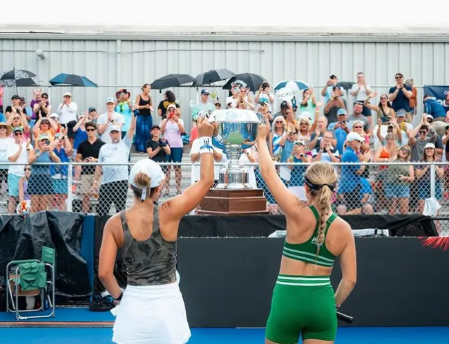 Anna Leigh Waters lifting a doubles trophy in front of the crowd at a PPA Tour event