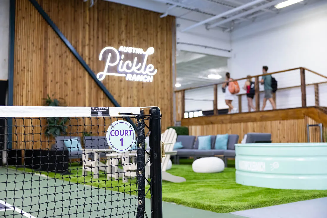 Indoor courts and players at Austin Pickle Ranch on Braker Lane