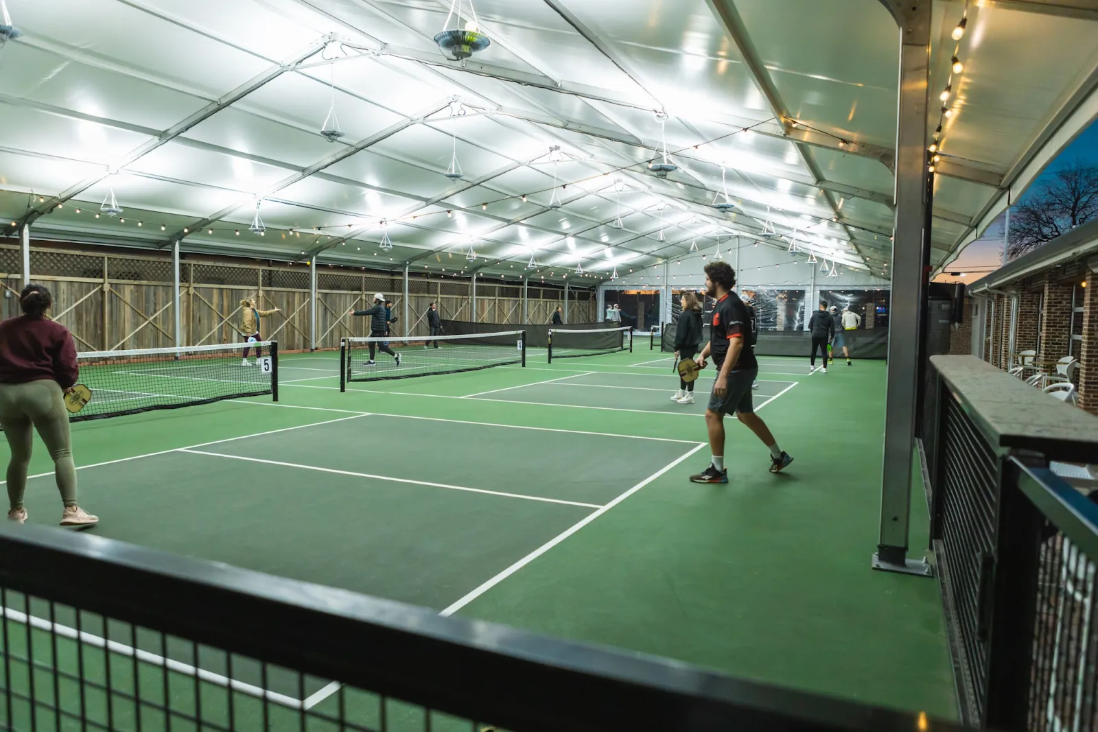 Outdoor pickleball courts and dining at Courtside Kitchen in Fort Worth