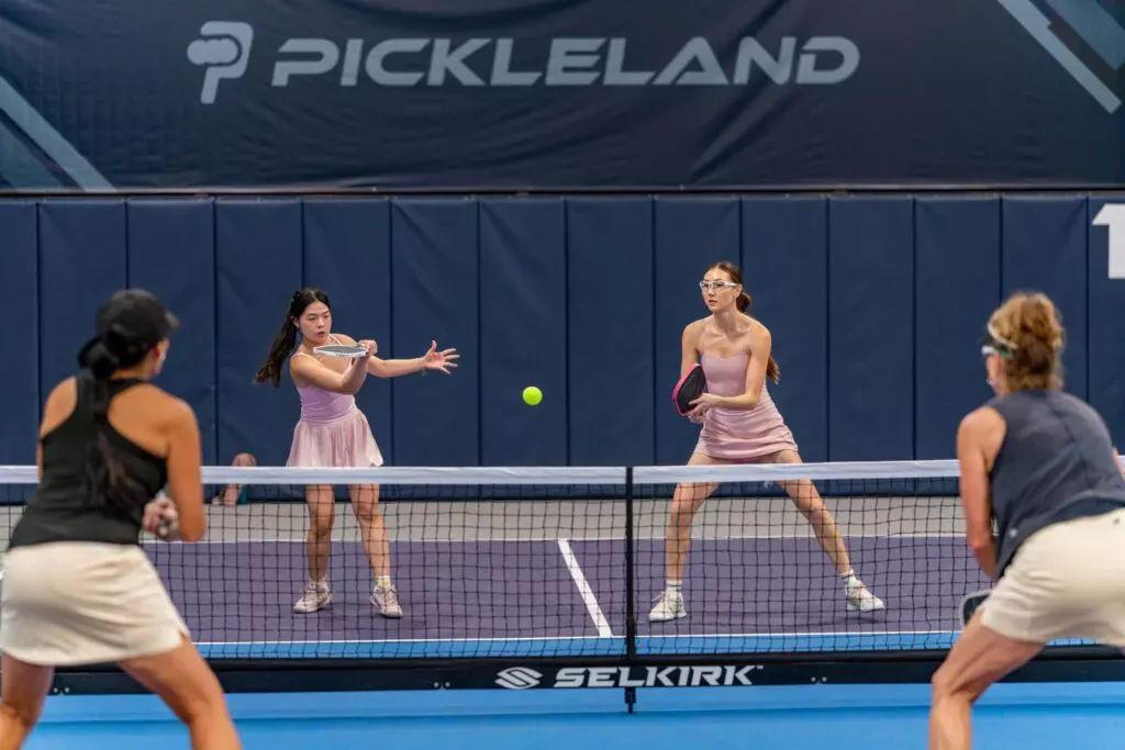 Pickleland paddles and gear displayed beside the courts