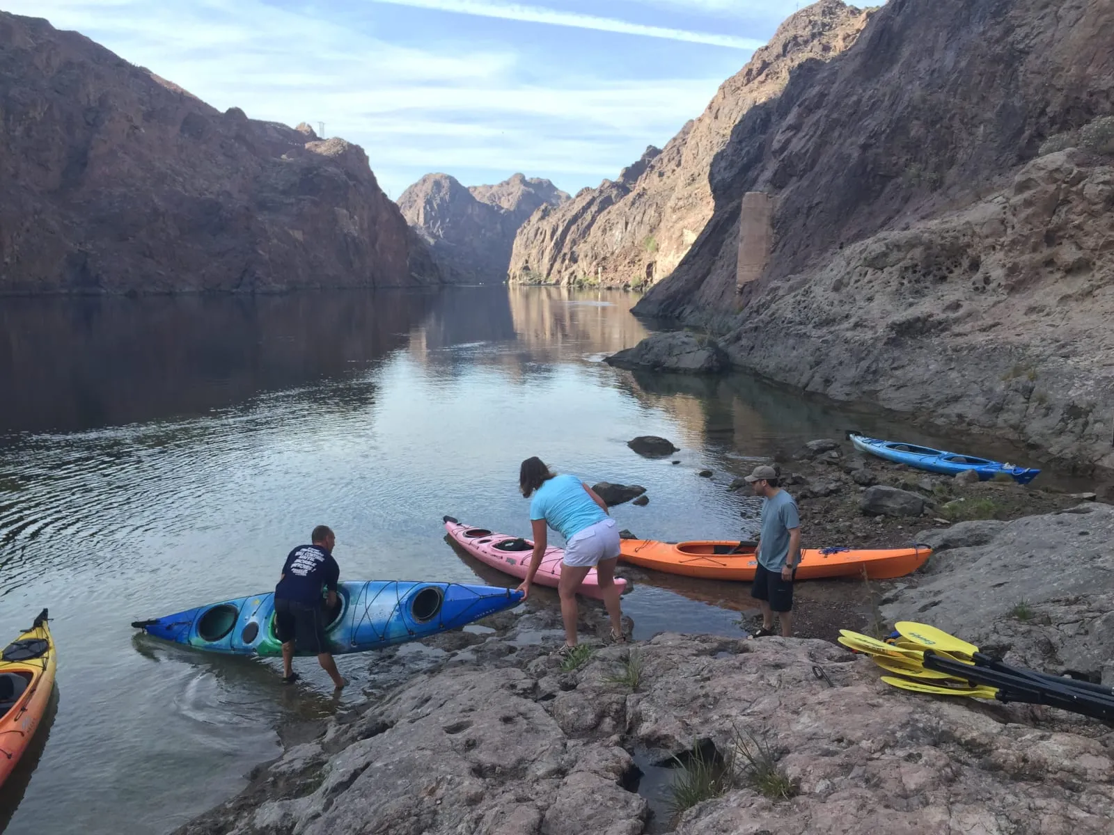 A couple kayaking on the Colorado River with the Austin skyline in the background