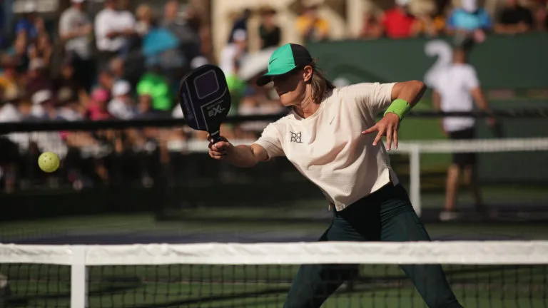 Pro pickleball player Irina Tereschenko preparing to return a shot