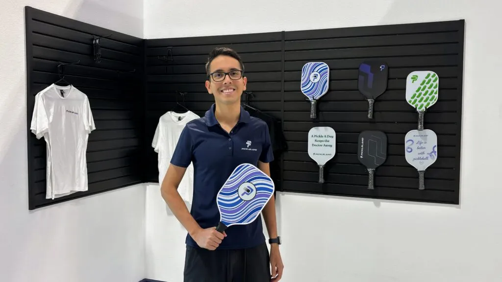 Player holding a pickleball paddle in the Continental hammer grip