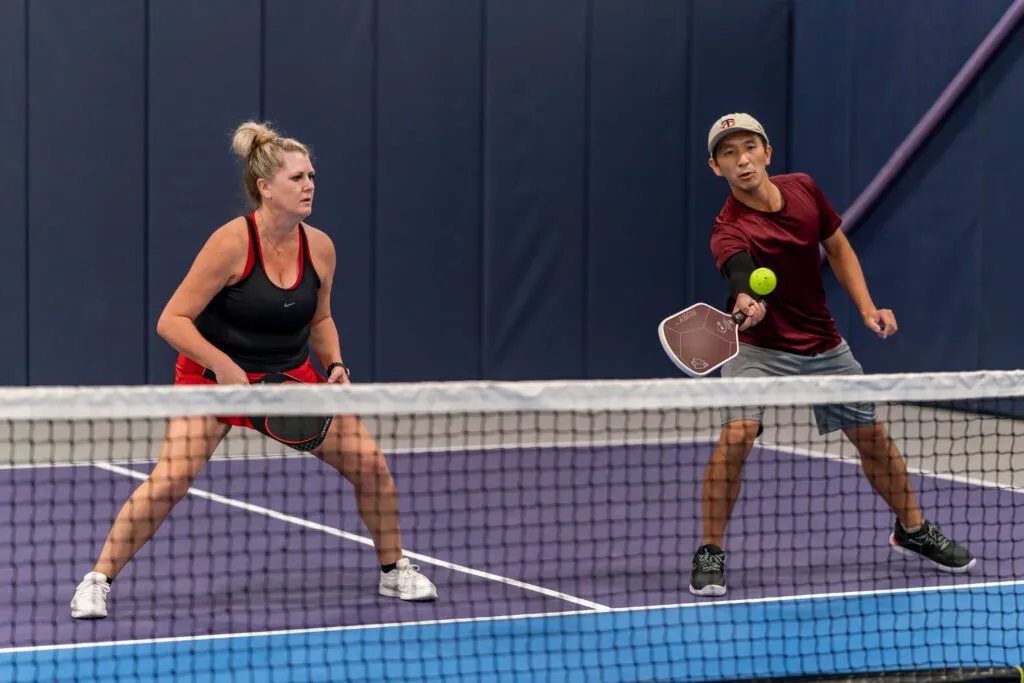Singles playing doubles pickleball together at Pickleland