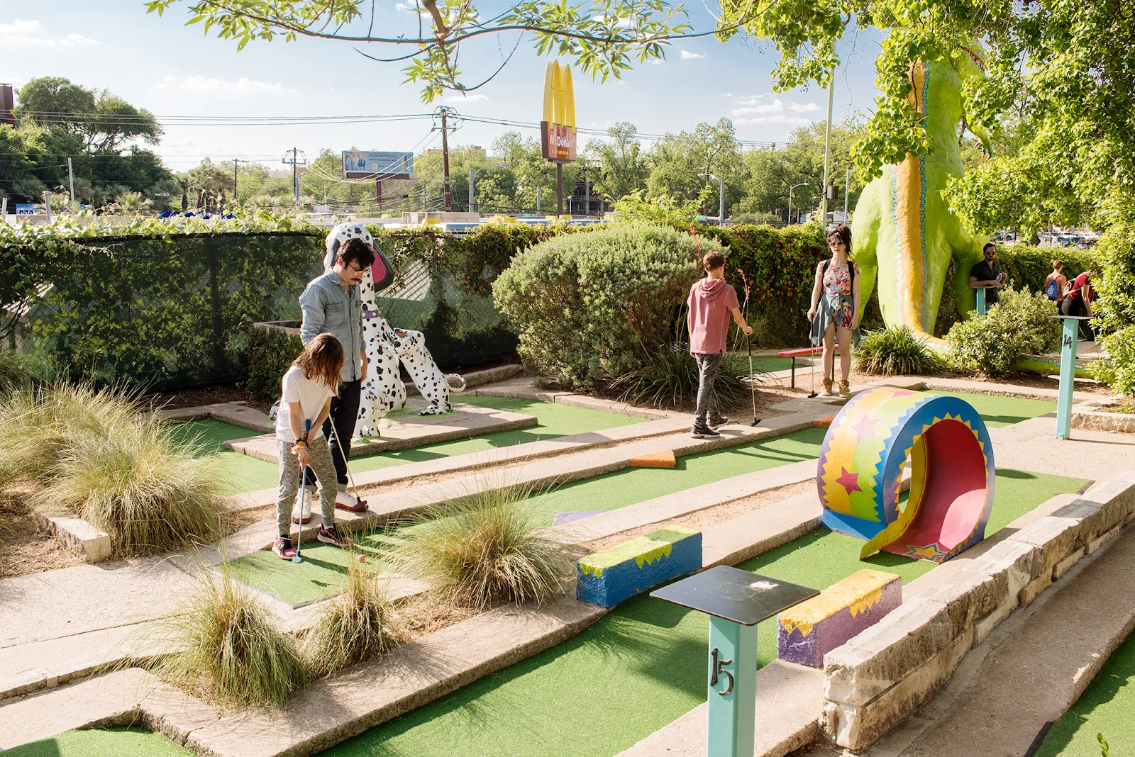 Player putting on a themed mini golf course in Austin
