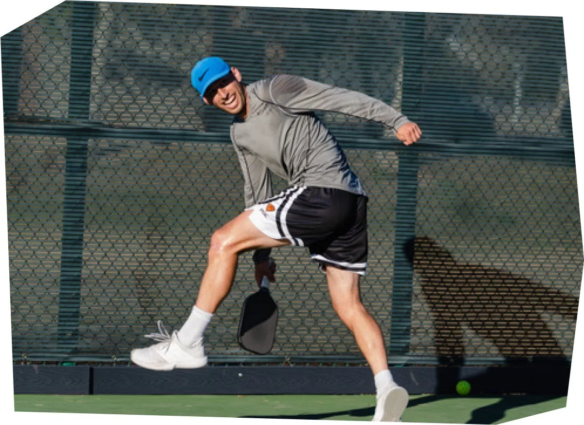 Kyle Koszuta lunging for a shot on the pickleball court