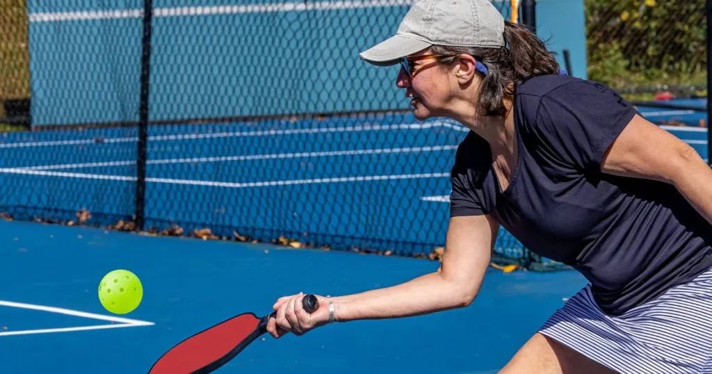 Player hitting a soft drop shot into the pickleball kitchen