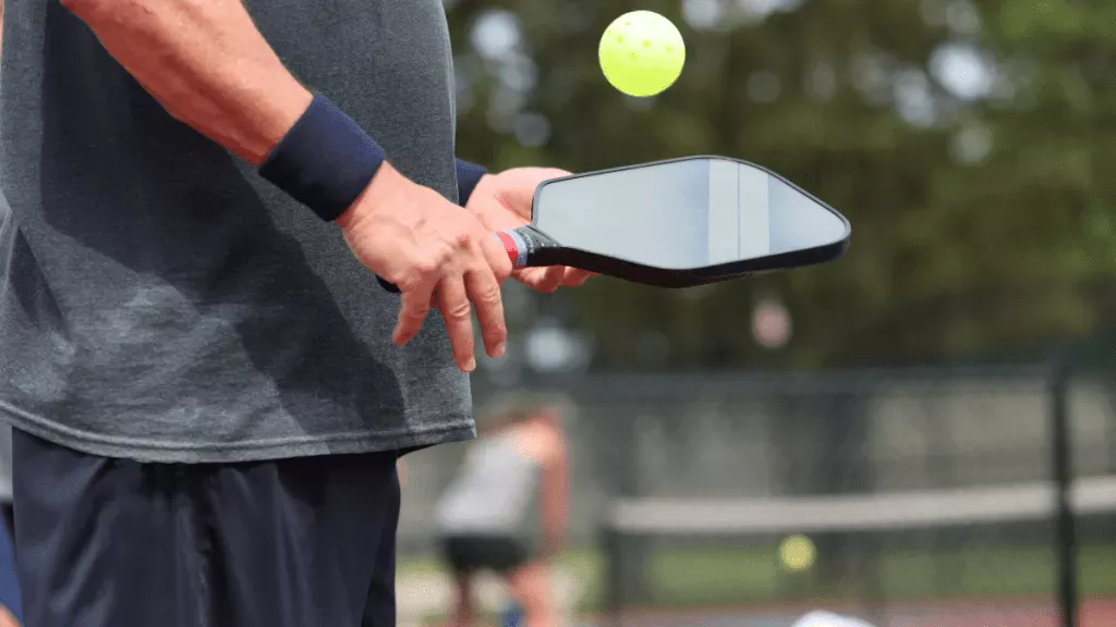 Players rallying on a pickleball court, illustrating why the sport is here to stay and not just a fad